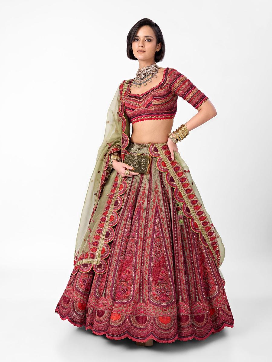 A coral and red lehenga, the border built from repeated geometric units