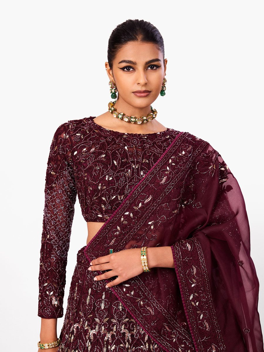 A deep wine lehenga with sequin embroidery and a sheer dupatta