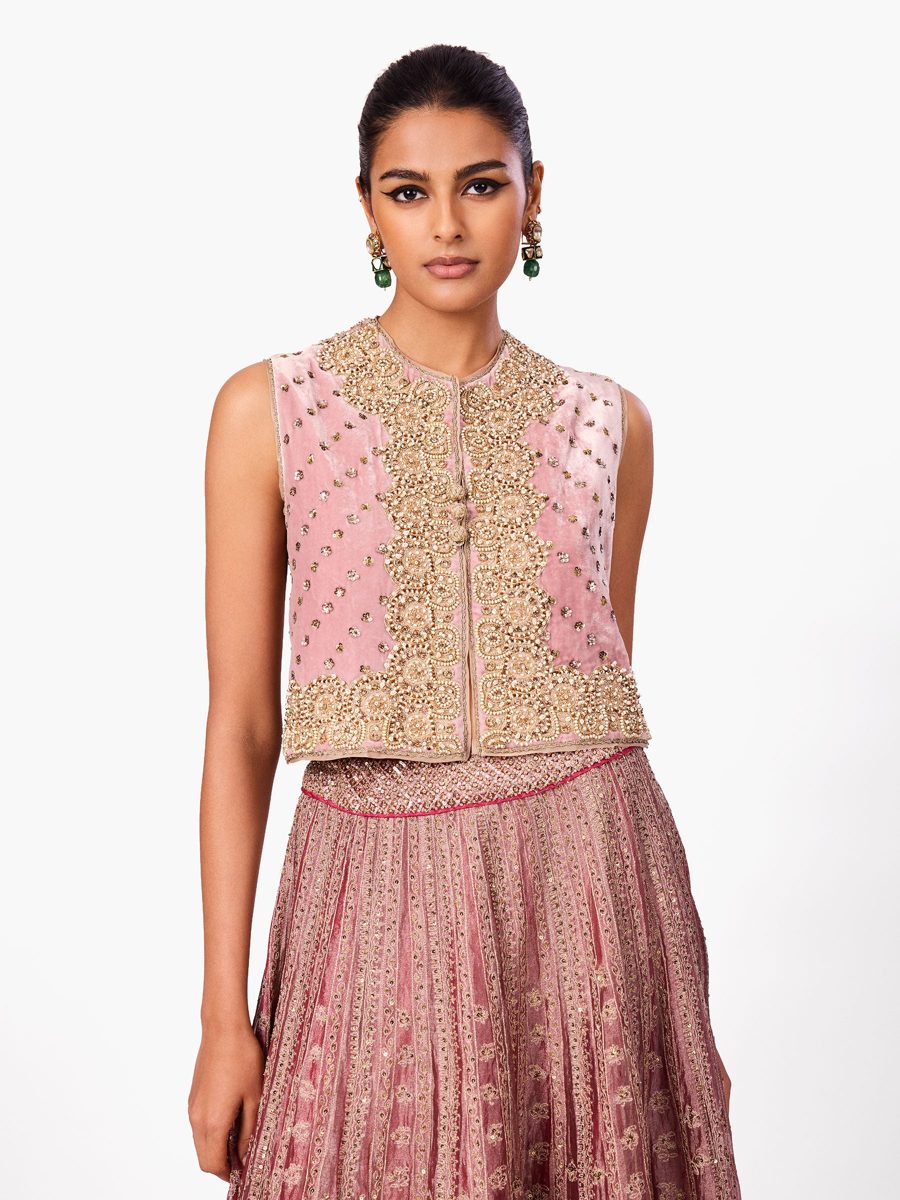 A pink lehenga with an embroidered waistcoat top